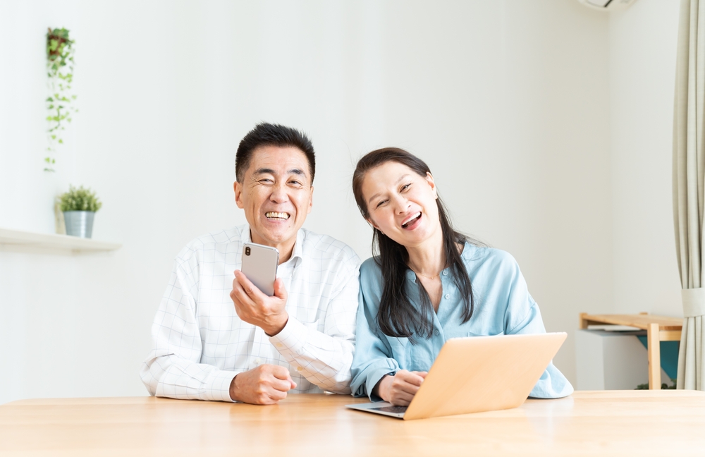 Asian couple using digital devices